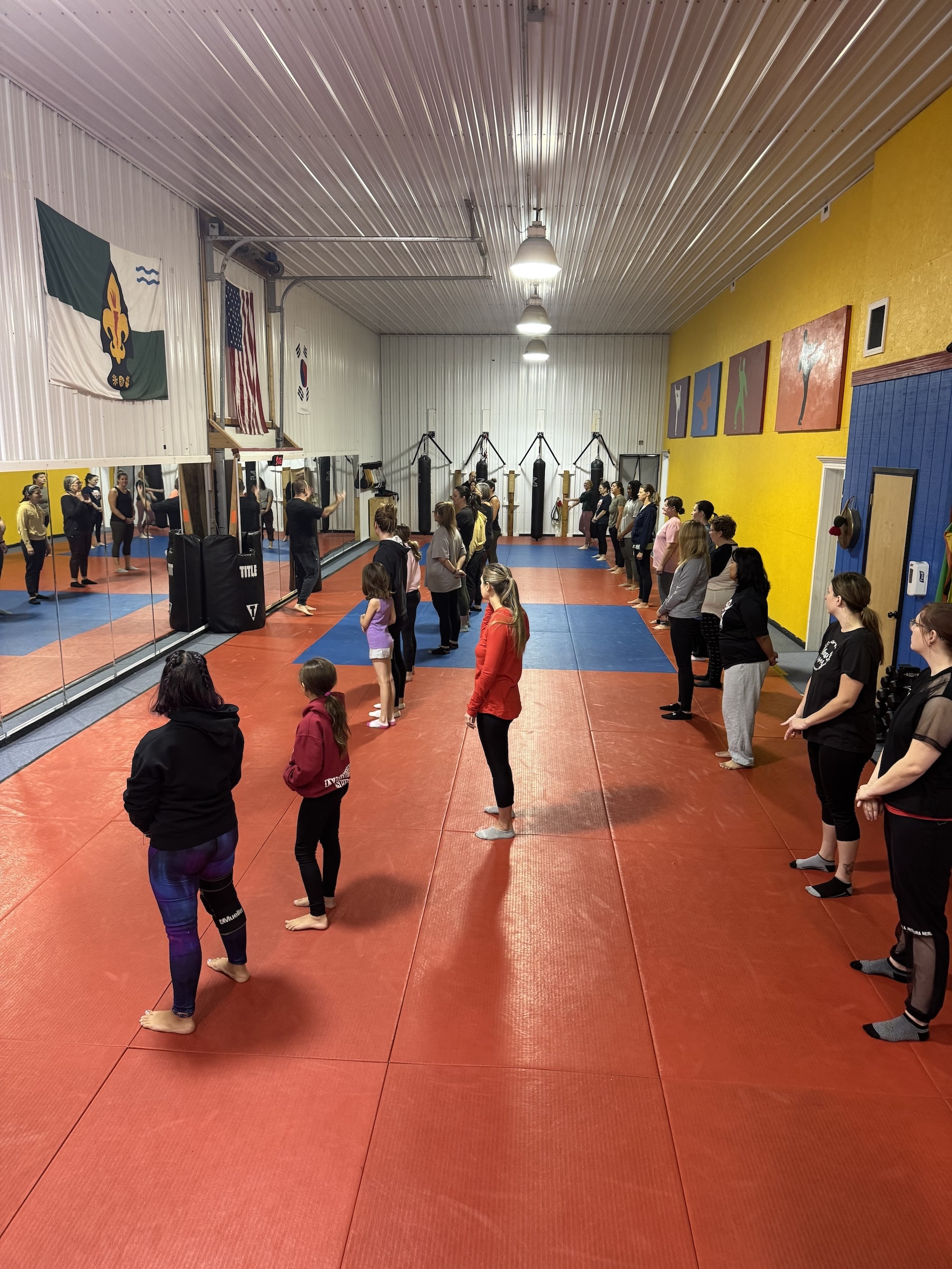 A classroom of students in street clothes facing the instructor