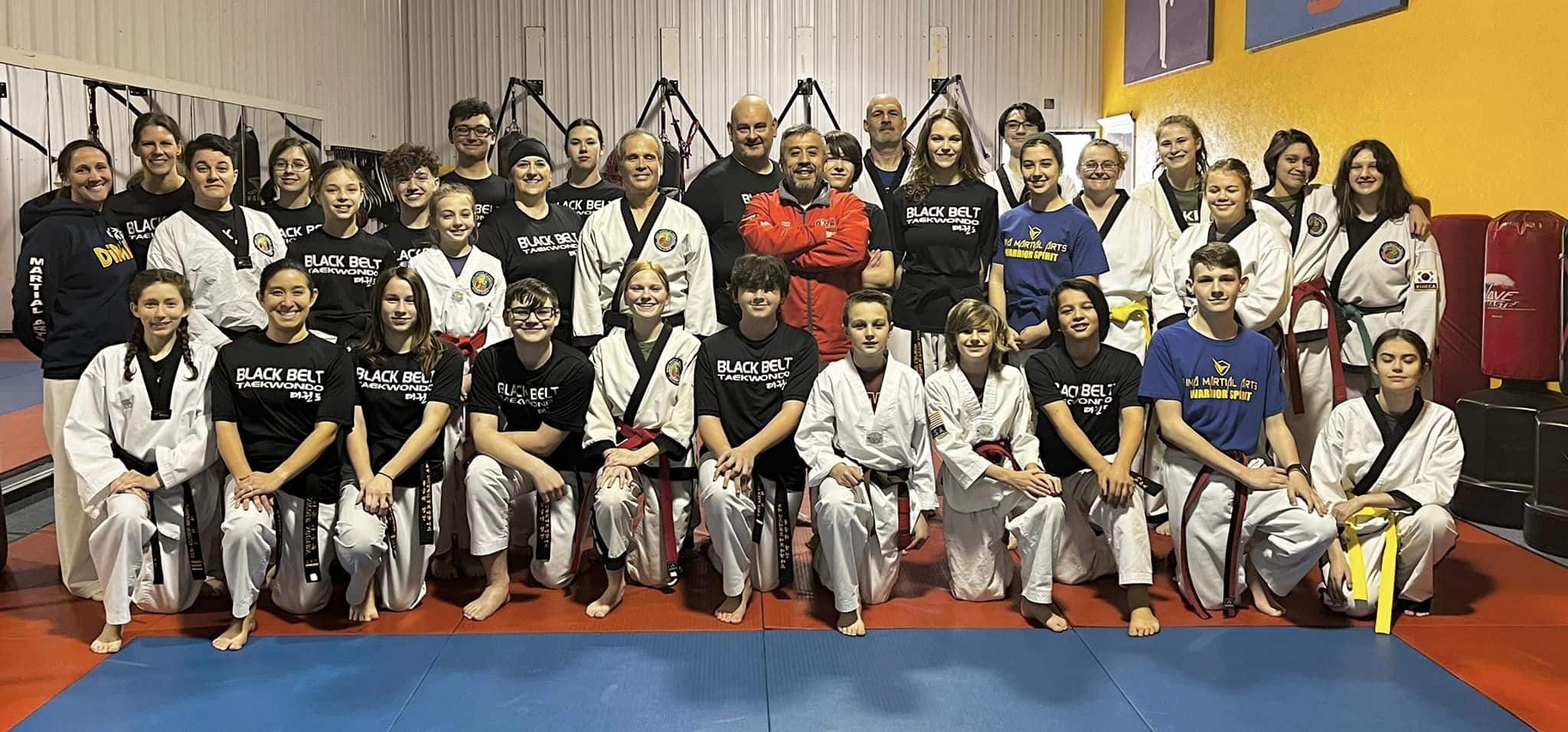 A group photo of members in gi and staff shirts