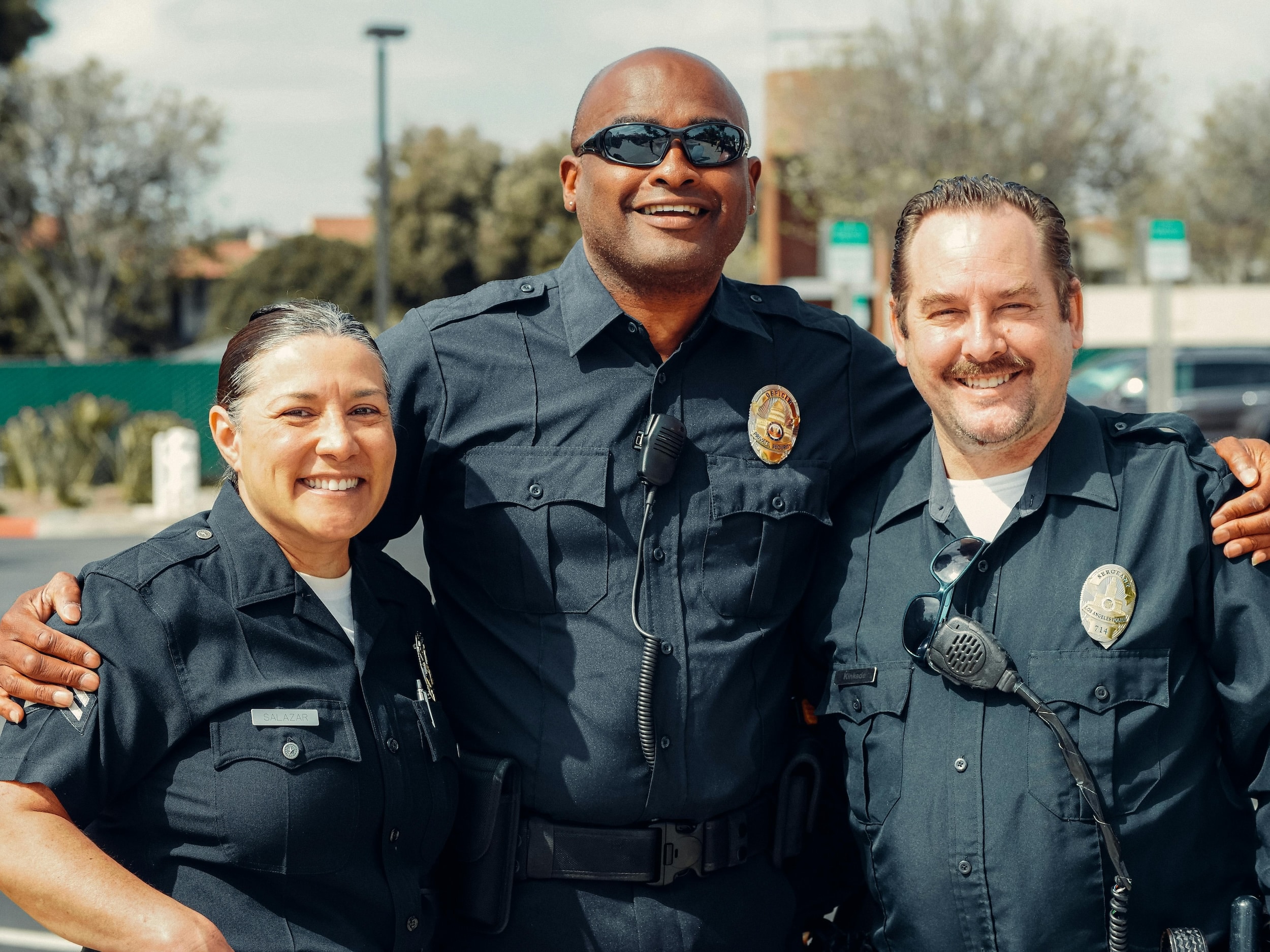 Three police officers smile for camera